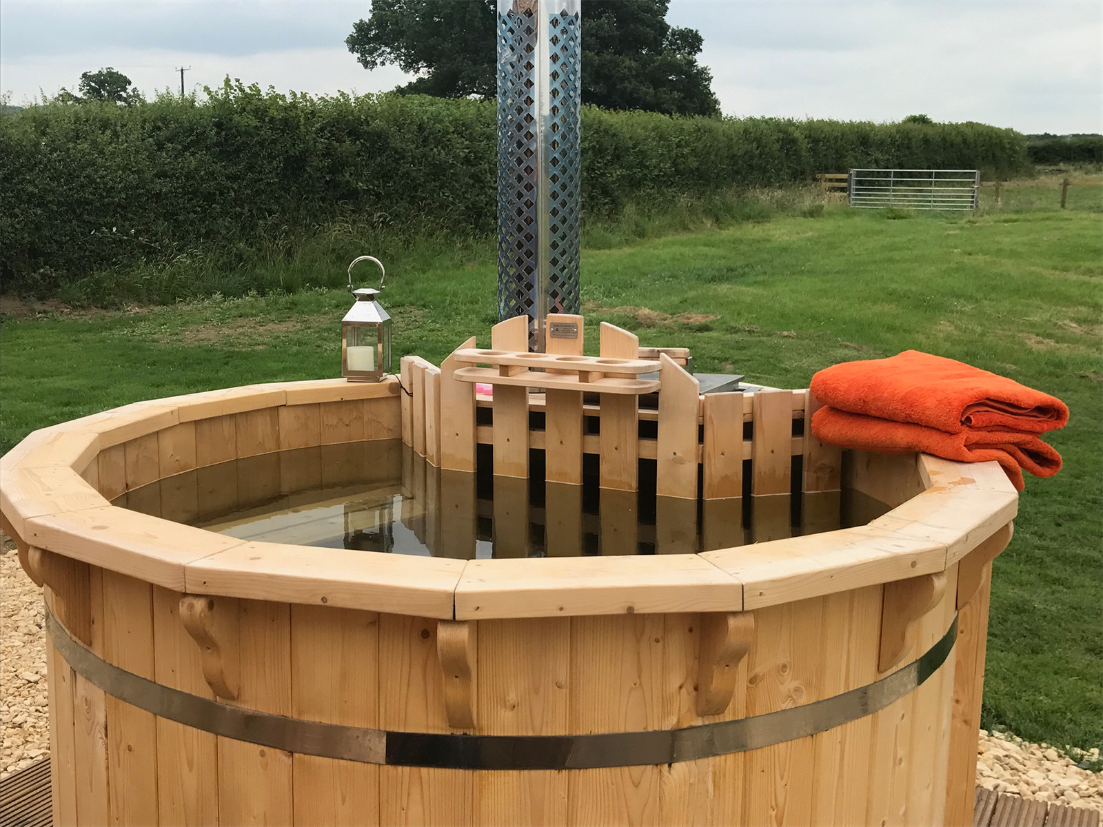 Luxury glamping pods with wood fired hot tubs at Evenlode Grounds Farm